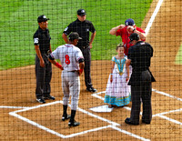 Managers meeting with umpire and young girl