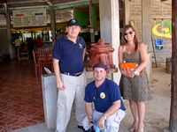 Julio, Isaac, and Chilean woman in front of restaurant