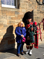 Anne and bagpipe player, Edinburgh, Scotland